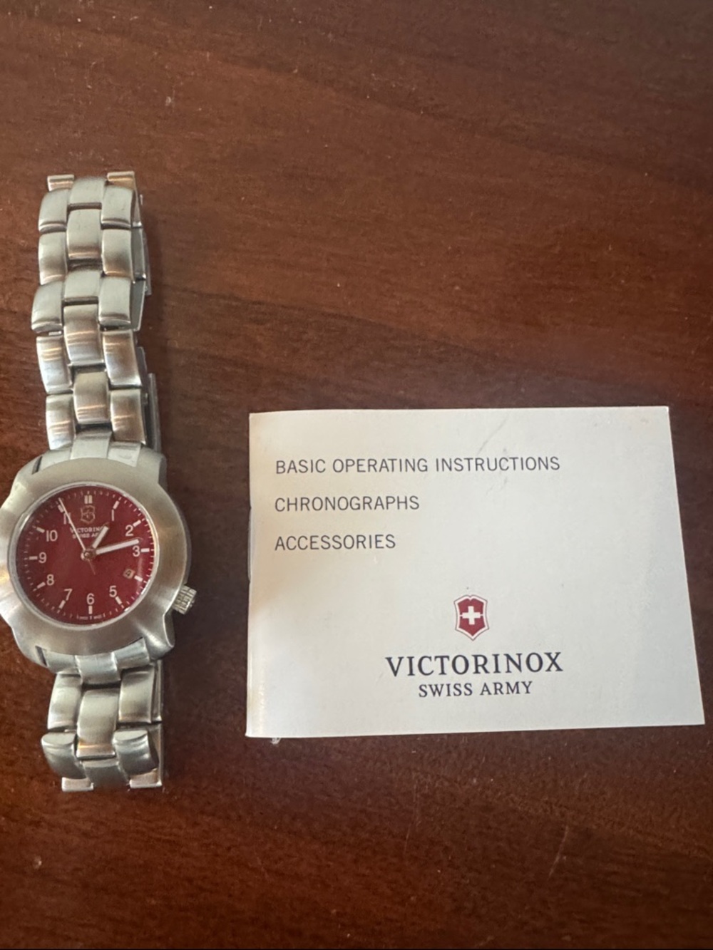 Victorinox Stainless Steel Watch with Red Dial and Silver Bracelet